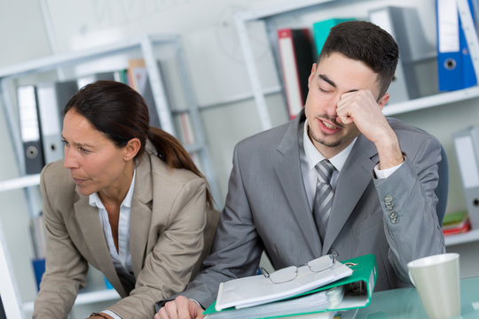 businessman tired solving problem in office with his co-worker