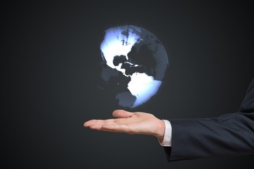 Holographic projection of Earth above mans hand.