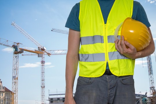 Worker with protective helmet on construction site.