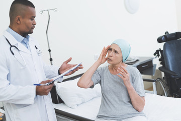 Obraz premium The doctor interrogates the woman. A woman undergoes rehabilitation after cancer treatment.