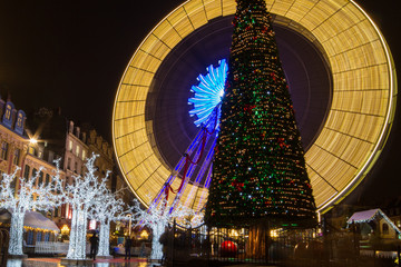 Lille, France, Christmas Market 2017 with Ferris wheel, big tree, lights and market stalls