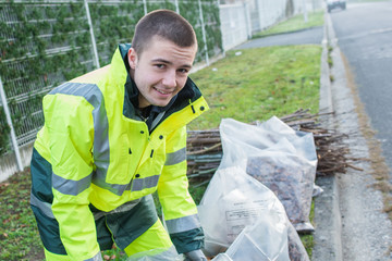 young worker collects debris