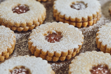 Close up of freshly baked homemade Christmas sugar cookies with jam
