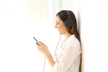 Happy girl listening music isolated at side