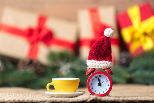 Christmas gifts and cup of tea with alarm clock