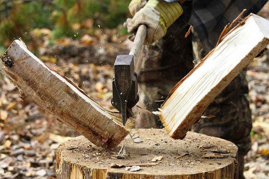 Task of splitting campfire wood while hunting