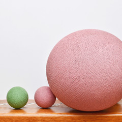Different sizes colorful cotton light balls as a decoration in home interior. Copy space.