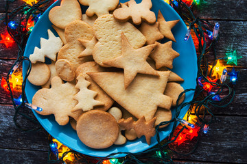 Plate with tasty   holiday Gingerbread Cookies on wooden table. Merry Christmas and Happy New Year card