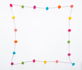 Pom Poms in a Curvilinear Square against a white background. Photographed at eye level. 