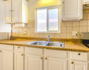Model home kitchen in southern California with view of the kitchen sink with granite counter top
