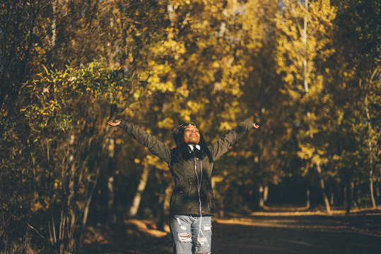 African girl open arms forest.