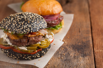 Set of three mini homemade Burger with marble beef and vegetables on a old wooden background. the concept of junk food and fast food. with copy space