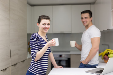 couple with laptop computer enjoying morning