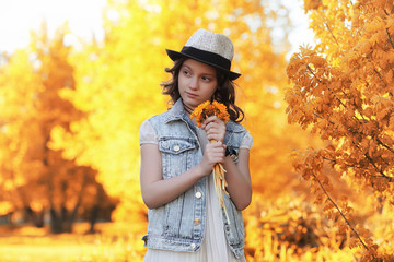 Girl walking in the autumn park. Autumn in the city, girl with d