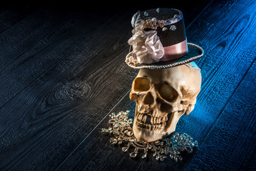 Skull in the cylinder. Human skull on a black background. Skull in the headdress.