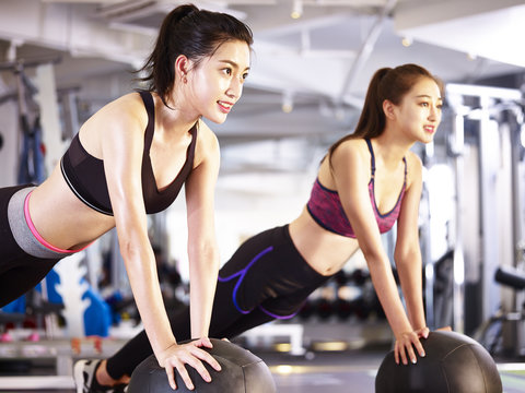 young asian women exercising with medicine balls