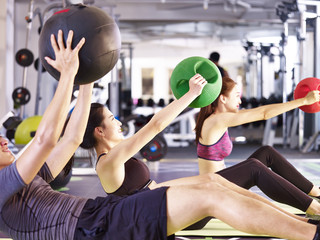young asian adults exercising with medicine ball