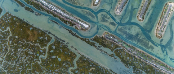 Aerial top down view seascape in Ria Formosa wetlands natural park, inland maritime channel. Algarve.