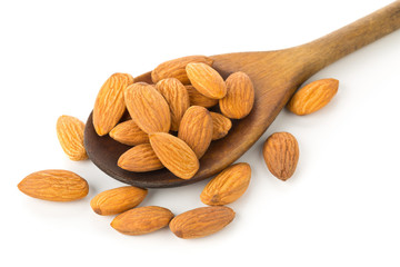 Heap of shelled almond kernels in wooden spoon