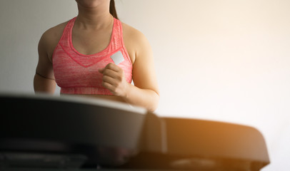 woman in sportswear running on treadmill