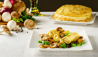 Hot Russian pancakes or blini with mushrooms.