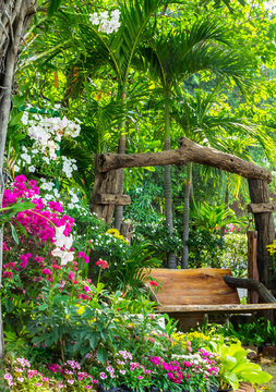 Wood chair in the flowers garden./ Wood chair in the flowers garden on summer. 