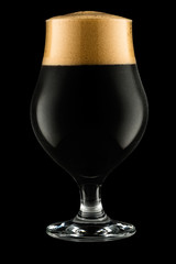 Glass of dark beer isolated on black background