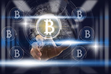 Businessman Finger touching the bitcoin icon over the light from blurred server room background, Fintech and AI concept