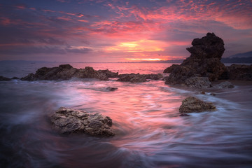 Seascape at sunset taken with long exposure to make slow movement