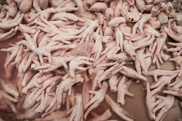Collection of chicken legs, fresh raw chicken legs, thai market, carnage concept, butchery background - obrazy, fototapety, plakaty