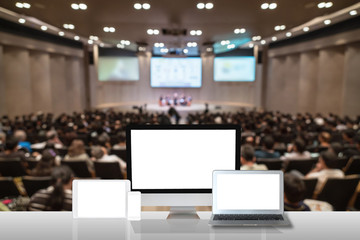 Computer set show on the white table over the Abstract blurred photo of conference hall or seminar...
