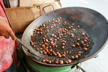 Local seller make roasted chesnut at Yaowarat, Bangkok, Thailand