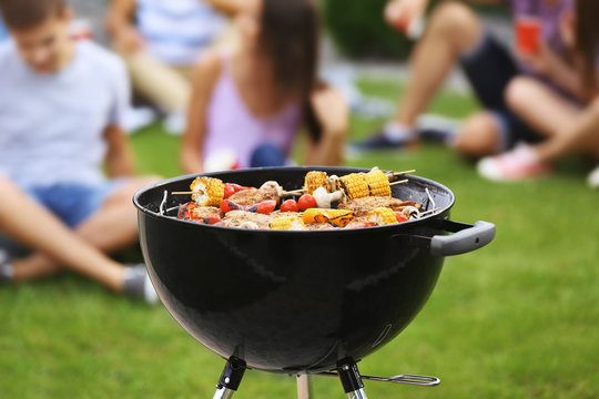 Tasty steaks and vegetables cooking on barbecue grill, outdoors