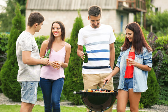 Young friends having barbecue party in garden