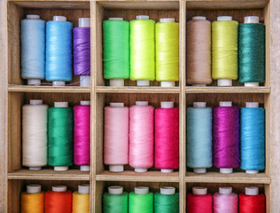 Wooden stand with different colorful threads
