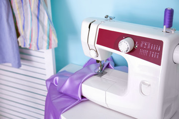 Sewing machine on table in tailor's workshop