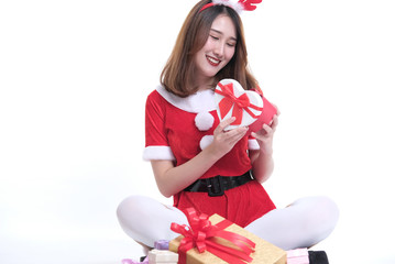 portrait of asian woman in santa claus dress on white background. girl with gift present box. christmas holiday. merry xmas celebration.