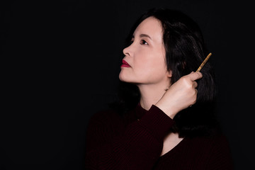 Obraz premium A close up portrait of an oriental woman on a black background