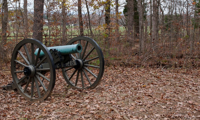 Fototapeta premium A Civil War cannon seen in the fall woods in Gettysburg, Pennsylvania