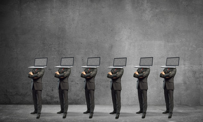 Businessmen with laptops instead of head.