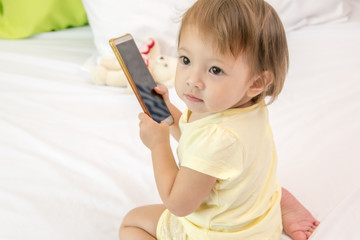 Baby kid using smartphone. Isolated on white background