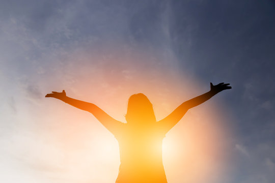 happiness and jouful woman girl rise hand up into sky background