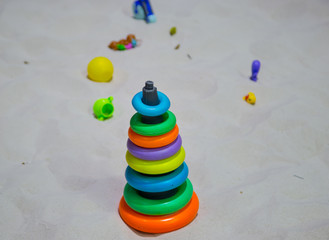 Colorful of ring pyramid on the beach. stacking tower toy. Kid education concept
