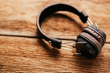 headphone on wooden texture background retro vintage concept