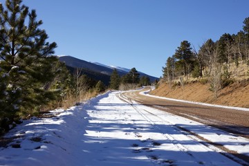 snow covered road winding up a mountain