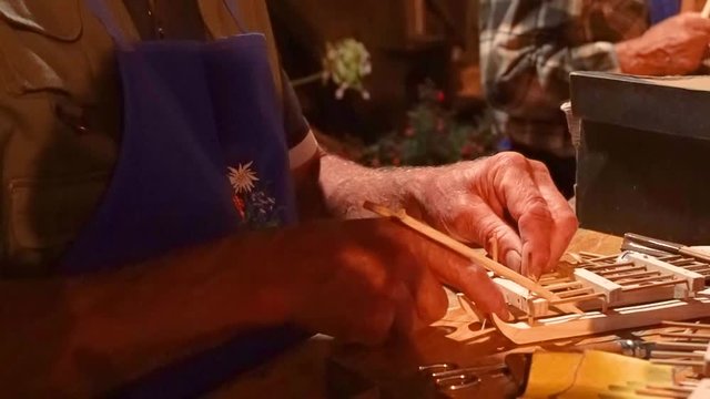 in town festival in trentino, Italy, a man make wood toys by his hands