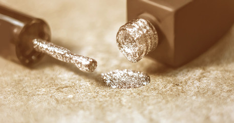Texture of shiny nail polish shine closeup.a bottle of nail polish next to the brush. The concept...
