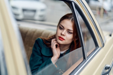 Fototapeta na wymiar Beautiful young woman in the car on the street, city, road, emotions
