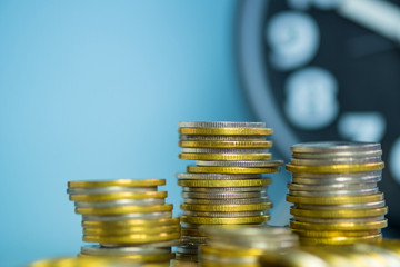 Stacks of coin with alarm clock with copy space, time for savings money concept, banking and business. shallow focus.