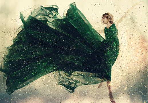 Beautiful Woman In A Green Dress Jumping